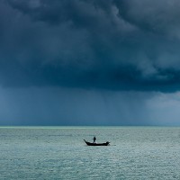 Fisherboat in approaching storm © Mattsahib | iStock